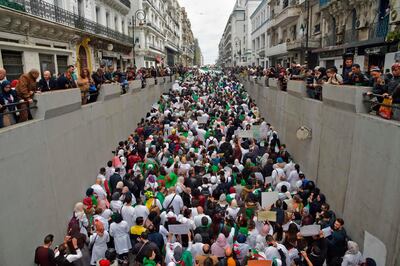 TOPSHOT - Algerians take part in a demonstration in the capital Algiers against President Abdelaziz Bouteflika on March 19, 2019.  Bouteflika today confirmed he will stay in power beyond his term expiring next month, despite tens of thousands of people demonstrating against his rule. / AFP / RYAD KRAMDI                        
