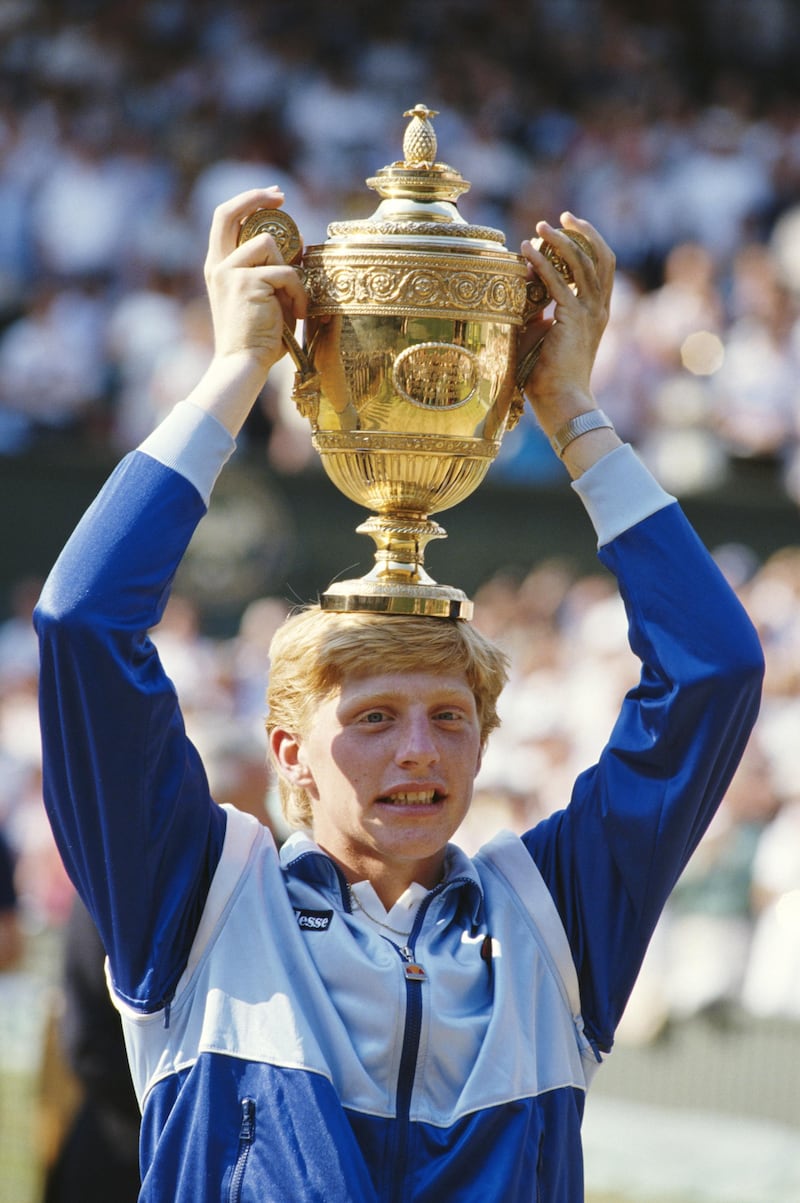 Boris Becker of Germany places the trophy on his head in to celebrate his defeat of Kevin Curren 6-3, 6-7 (4-7), 7-6 (7-3), 6-4 during the Men's Singles final of the Wimbledon Lawn Tennis Championship on 7th July 1985 at the All England Lawn Tennis and Croquet Club in Wimbledon in London, England. It was Becker's 1st career Grand Slam title and his 1st Wimbledon title. (Photo by Steve Powell/Getty Images) 
