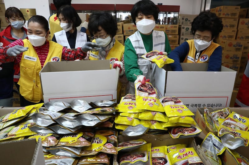 South Korean Red Cross workers prepare emergency relief kits packed with basic necessities for delivery to impoverished people experiencing difficulties amid the spread of coronavirus. Getty Images