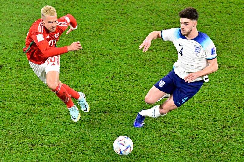 Wales midfielder Aaron Ramsey fights for the ball with England's Declan Rice. AFP