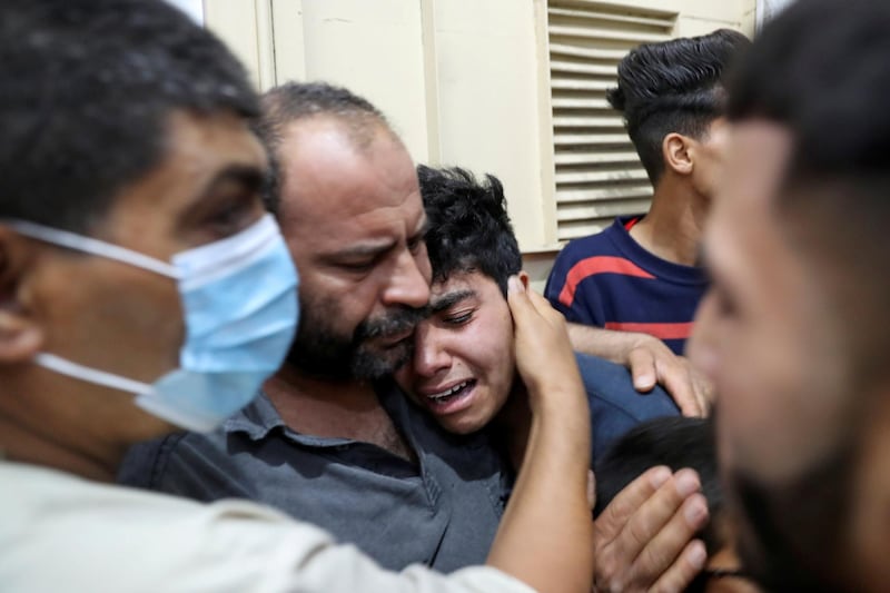 A relative of a Palestinian killed during Israeli-Palestinian clashes is comforted at a hospital in the northern Gaza Strip. Reuters