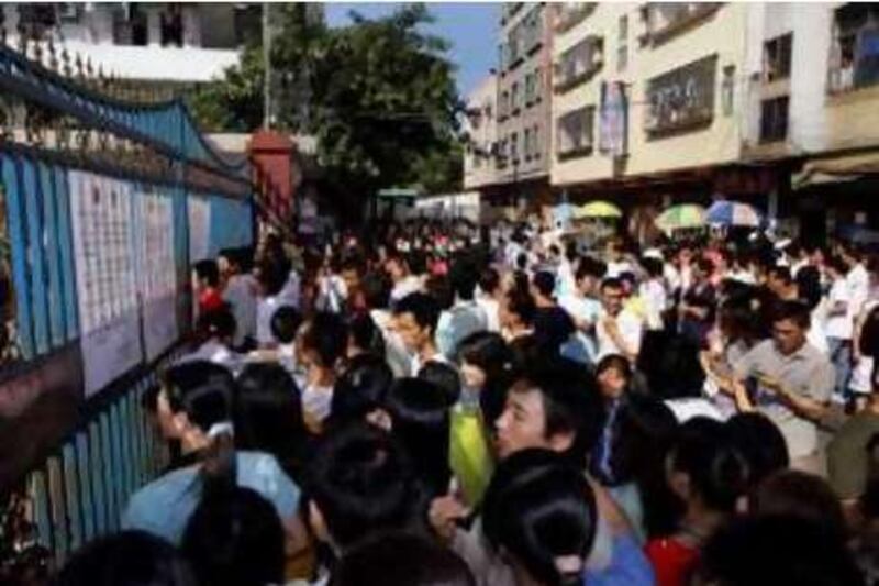 Hundreds of workers gather outside a large toy factory in Zhang Mu Tou of Guangdong province, of southern China Friday, Oct. 17, 2008. Hundreds of workers protested Friday for a third straight day outside the factory that closed in southern China amid a global slowdown that has begun hurting Chinese manufacturers. (AP Photo/Vincent Yu)