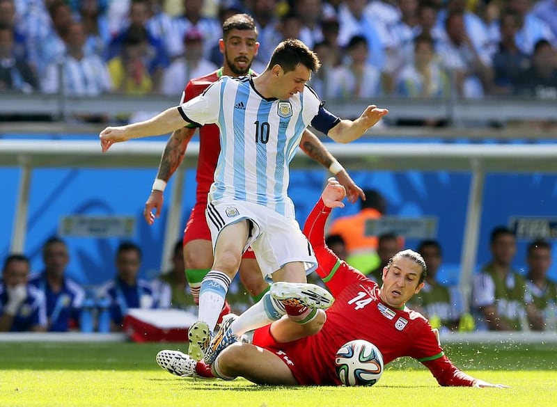 Lionel Messi, centre, of Argentina in action against Andranik Teymourian, right, of Iran during their match on Saturday at the 2014 World Cup. Dennis Sabangan / EPA