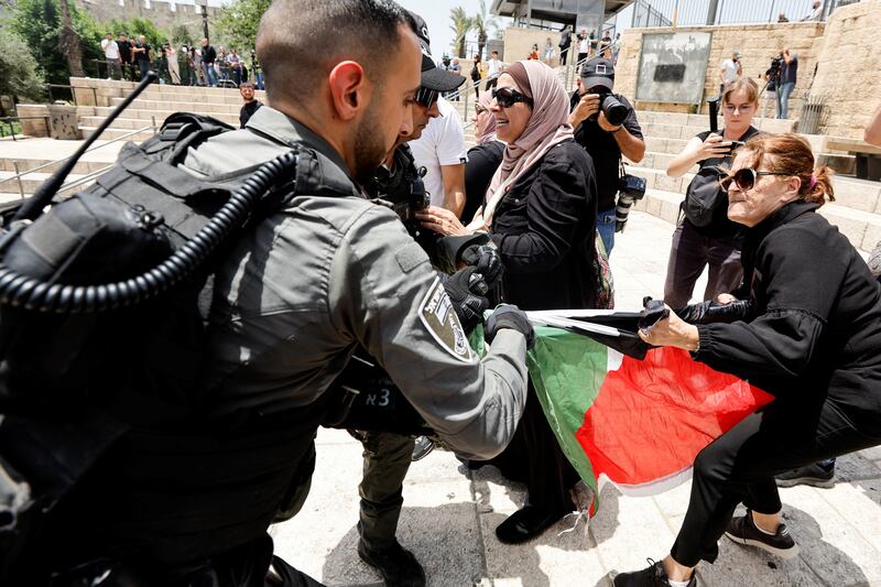 A tug of war ensues over a Palestinian flag. Reuters