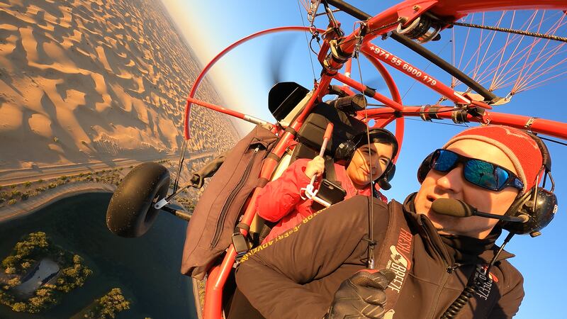 'The National's reporter Sarwat Nasir takes a ride on a paramotor, piloted by Mr Ctitor.