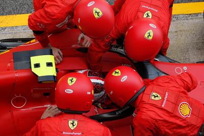 BARCELONA, SPAIN - AUGUST 16: Ferrari members try to fix the problem with the car of Charles Leclerc of Monaco and Ferrari during the F1 Grand Prix of Spain at Circuit de Barcelona-Catalunya on August 16, 2020 in Barcelona, Spain. (Photo by Emiliano Morenatti/Pool via Getty Images)