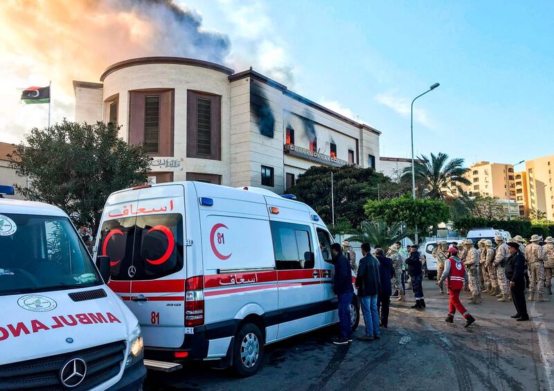 Ambulances, paramedics, and security officers at the scene of an attack outside the Libyan foreign ministry headquarters in the capital Tripoli. AFP