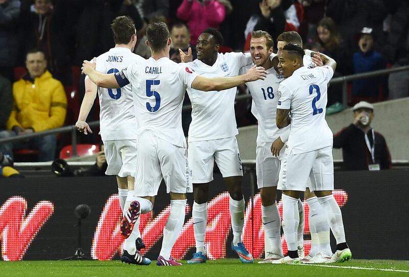 Harry Kane, third right, celebrates scoring on his England debut with teammates on March 27. Dylan Martinez / Reuters