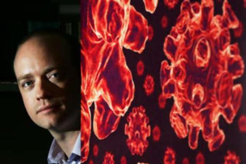 Christian Enemark, the co-director of the national Centre for Biosecurity, at his office in Sydney beside an image of the influenza virus.