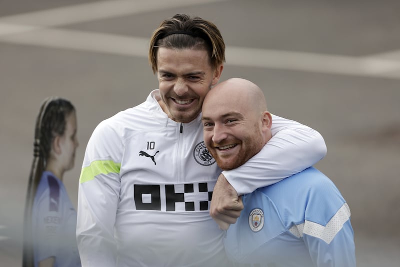 Manchester City's Jack Grealish with kitman Brandon Ashton. PA