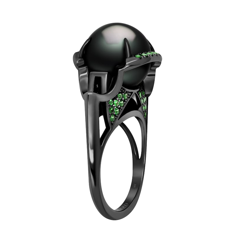 The Isis Goddess Pearl Ring by Angie Marei features a rare, exotic and luminescent Tahitian black pearl, enthroned in an 18-carat black gold setting bejewelled in pave set green tsavorite garnets and detailed with hand-painted black enamel