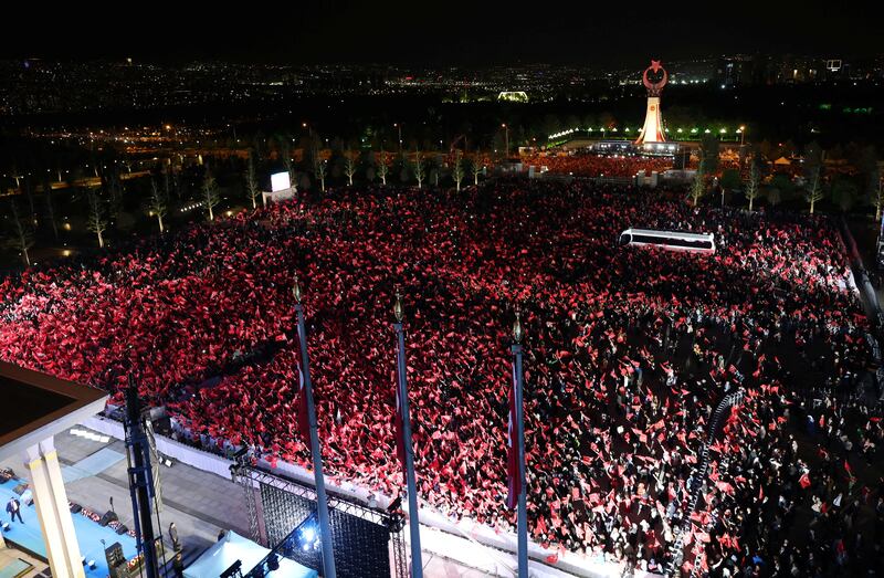 Mr Erdogan's supporters wave Turkish flags as they wait for him to make a speech at the Presidential Palace in Ankara. Reuters