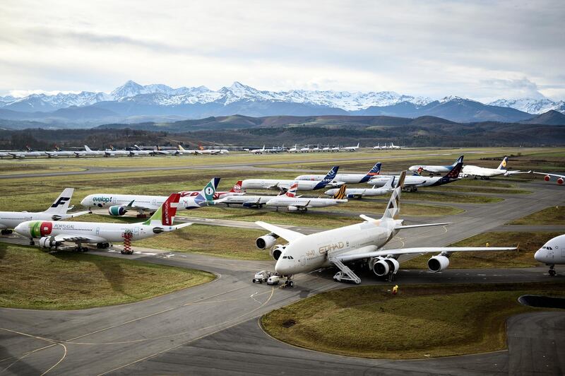This picture taken on February 4, 2021, shows aeroplanes stocked by TARMAC Aerosave, an aircraft recycling and storage company, are pictured on the company parking area in Azereix, southwestern France. - At the foot of the snow-capped Pyrenees, dozens of planes from all over the world are carefully aligned like toys in a giant parking lot. Since the Covid-19 crisis, the Tarmac Aerosave company has been drowning in requests for storage from airlines. (Photo by Lionel BONAVENTURE / AFP) / RESTRICTED TO EDITORIAL USE, TO ILLUSTRATE THE EVENT AS SPECIFIED IN THE CAPTION
