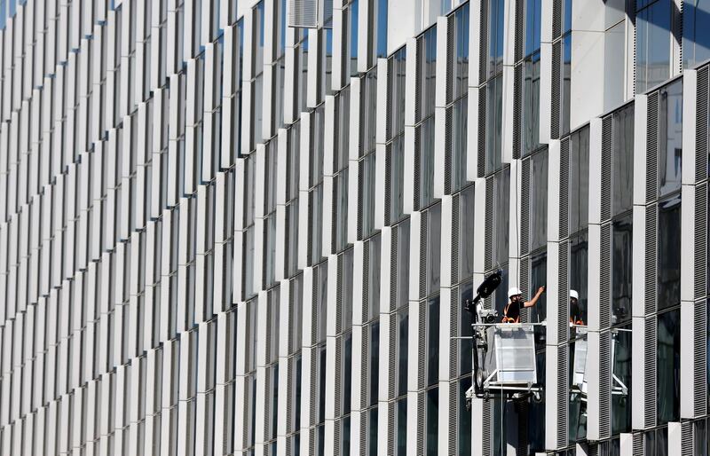 A window cleaner works on the facade of the new NATO headquarters building in Brussels, Belgium. Francois Lenoir / Reuters