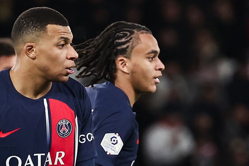 PSG players Kylian Mbappe and his brother Ethan look on during a French L1 football match between PSG and FC Metz in Paris. AFP