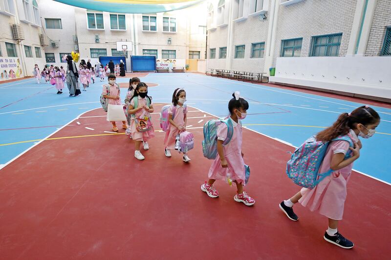 Children arrive at school as in-person classes resume amid the pandemic in Kuwait City.