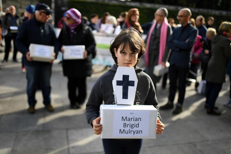 FILE PHOTO: Matilda Kelly holds a funeral box at a funeral procession in remembrance of the bodies of the infants discovered in a septic tank, in 2014, at the Tuam Mother and Baby Home, in Dublin, Ireland October 6, 2018. REUTERS/Clodagh Kilcoyne/File Photo