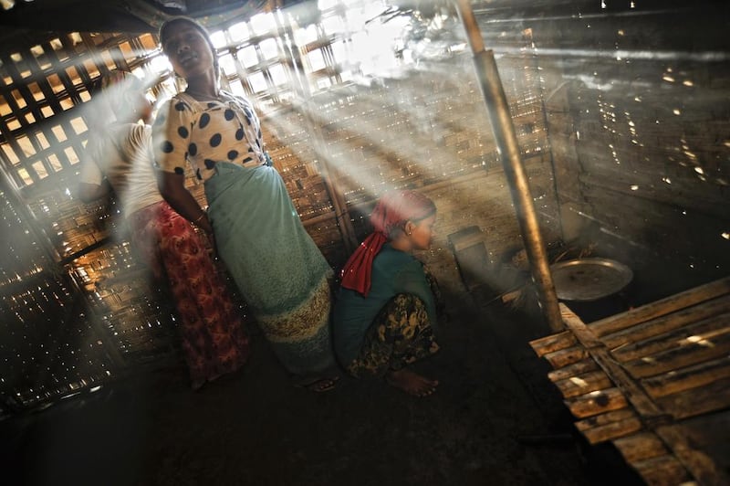 Sisters of Senwara Begum prepare a meal for the family at the Ohn Taw refugee camp on the outskirts of Sittwe, Myanmar. AP Photo/Kaung Htet