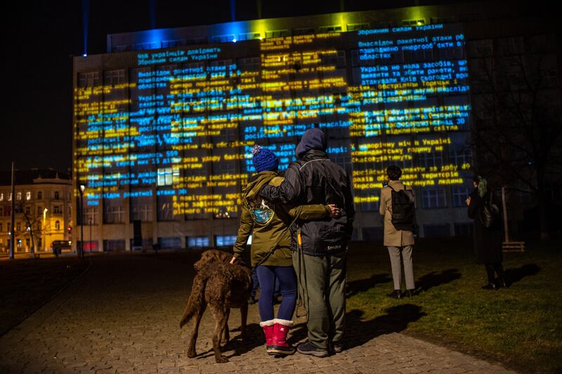 Watching video-mapping on the Czech Interior Ministry building, in Prague. EPA