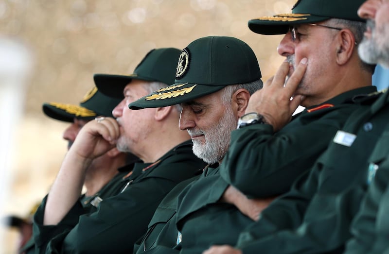 In this June 30, 2018 photo, released by an official website of the office of the Iranian supreme leader, Gen. Qassem Soleimani, center, who heads the elite Quds Force of Iran's Revolutionary Guard attends a graduation ceremony of a group of the guard's officers in Tehran, Iran. Soleimani said Thursday his forces are ready if President Donald Trump follows through on his warning that Iran will "suffer consequences" if Tehran threatens the United States. (Office of the Iranian Supreme Leader via AP)