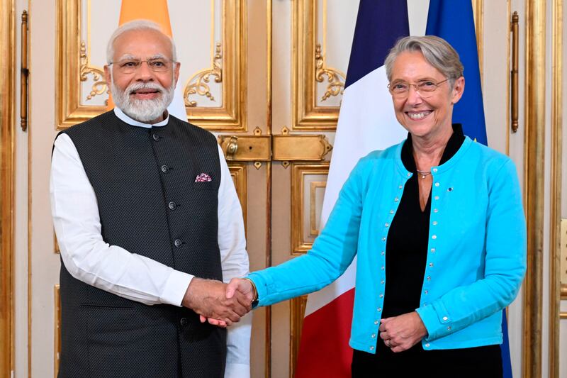 French Prime Minister Elisabeth Borne shakes hands with Mr Modi before talks in Paris. AP