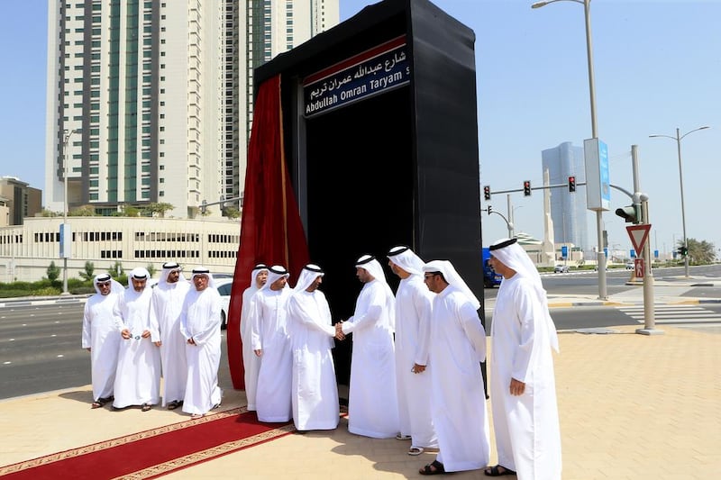 Saeed Al Ghafli, fifth from right, chairman of the Department of Municipality Affairs, greets Khalid Abdullah Omran after Inaugurating the street on Al Reem Island in Abu Dhabi to honour his father Abdullah Omran Taryam. Ravindranath K / The National