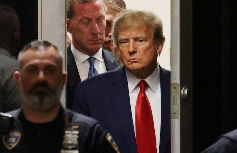 Mr Trump walks towards the Manhattan Criminal Court room in New York. EPA