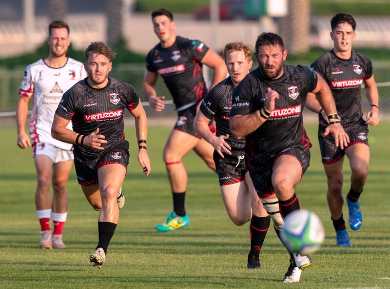 David Gairn of the Dubai Exiles sprints for the ball during their match against the Abu Dhabi Harlequins at Zayed Sports City. All photos by Victor Besa / The National