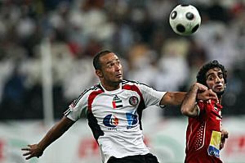 Al Jazira's Brazilian striker Fernando Baiano, left, under pressure from Al Ahli's Khaled Mohammed, scored his 18th goal of the season.