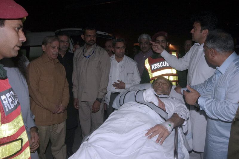 Officers and rescue workers move Pakistan's Interior Minister Ahsan Iqbal on a stretcher, after he was shot during a rally in Narowal and transported for medical attention to Lahore, Pakistan May 6, 2018. Picture taken May 6, 2018. Directorate General Public Relations (DPGR) Punjab/Handout via REUTERS  ATTENTION EDITORS - THIS IMAGE WAS SUPPLIED BY A THIRD PARTY. NO RESALES. NO ARCHIVES.