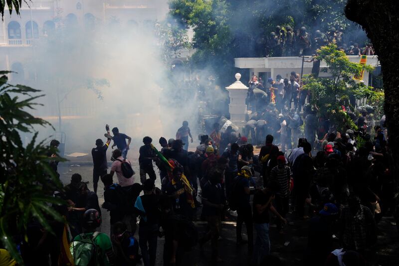 Police use tear gas to disperse Sri Lankan protesters outside the prime minister's office. AP