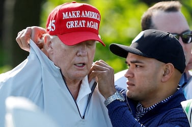 Walt Nauta, personal aide to former U. S.  President Donald Trump who faces charges of being Trump's co-conspirator in the alleged mishandling of classified documents, fixes Trump's collar before a LIV Golf Pro-Am golf tournament at the Trump National Golf Club in Sterling, Virginia, U. S.  May 25, 2023.   REUTERS / Jonathan Ernst     TPX IMAGES OF THE DAY
