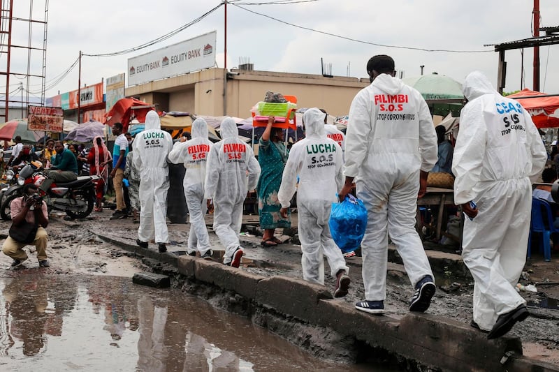 Activists walk along the street during a Covid-19 awareness campaign in Kinshasa.  Many people in Kinshasa deny the reality of the coronavirus which has officially affected 2833 people and killed 61, with a growing number of daily new cases.  AFP