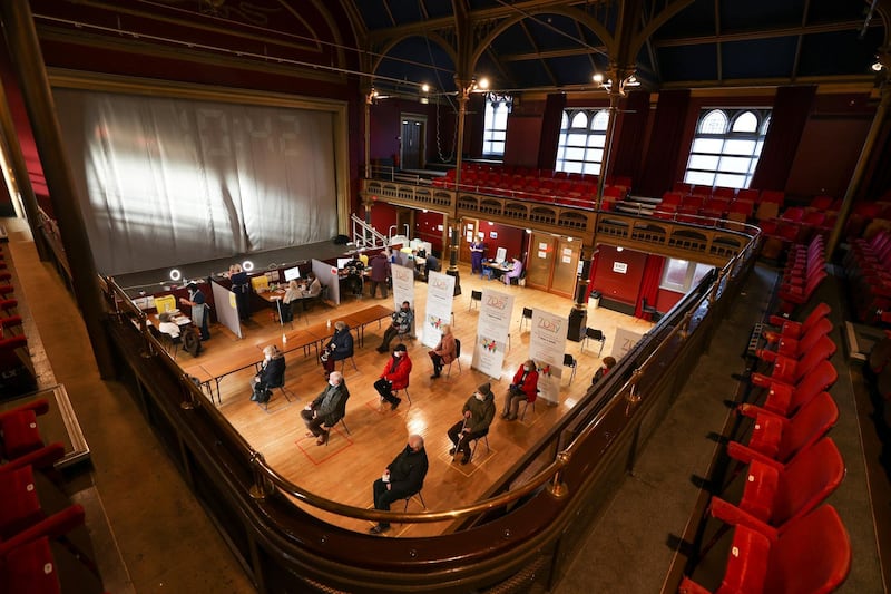 People practice social distancing as they wait to receive a dose of a Covid-19 vaccine at a community vaccination centre at Hartlepool Town Hall. Reuters