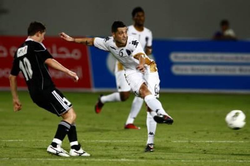 Al Ain, United Arab Emirates, Aug 19 2011, Al Ain vs Al Shabab of Saudi- (right) Al Ain's player #6 Mirel radoi passes the ball at midfield as  Al Shabab's #10 serfer de jebarov watches during action at Sheikh Khalifa International Stadium in Al Ain.  Al Ain and Al Shabab tied 1-1 at the end of play. Mike Young / The National?