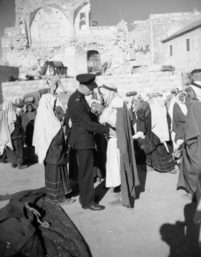 A British policeman searches an Arab in Bethlehem for weapons in 1947.  Arabs were not allowed to carry knives or other weapons in the municipal area at the time. AP Photo