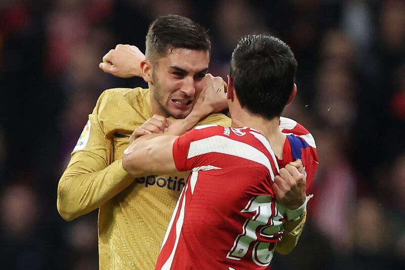 Barcelona's Spanish forward Ferran Torres fights with Atletico Madrid's Montenegrin defender Stefan Savic. Both were sent off in second-half injury time. AFP