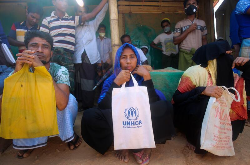 Rohingya refugees at the Kutupalong refugee camp in Cox’s Bazar, Bangladesh. Aid workers are bracing for a possible outbreak of coronavirus in one of the world's largest refugee camps in Bangladesh. Officials warn that containing the disease among more than one million tightly packed Rohingya Muslims will be a daunting task. Suzauddin Rubel / AP