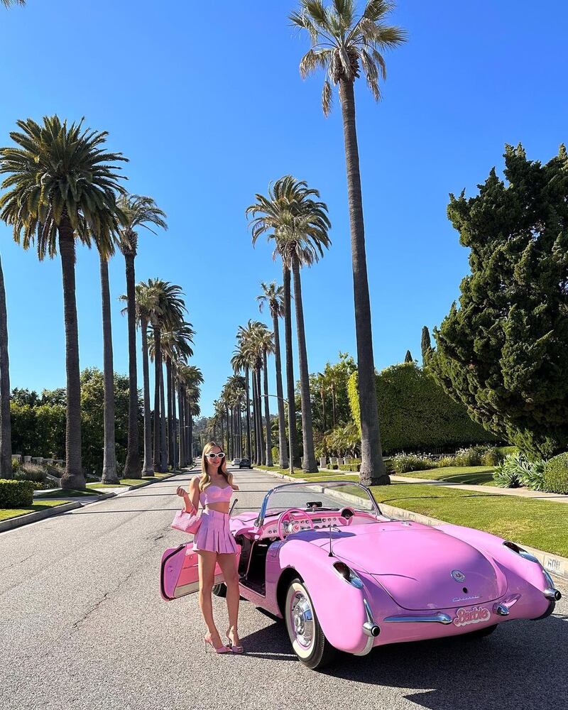 Beverly Hills: Robbie co-ordinated with her convertible in a pink Bottega Veneta outfit and custom-pink Manolo Blahnik Jada heels. Photo: Warner Bros