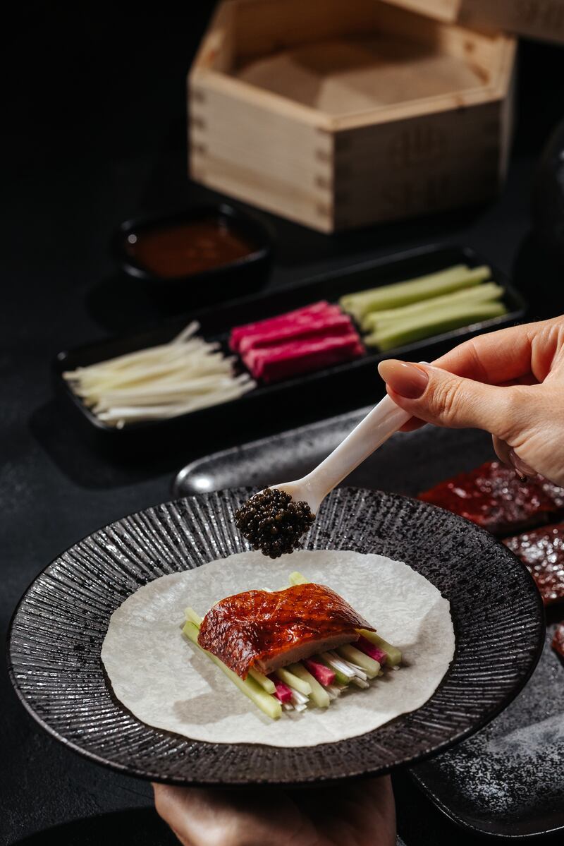 Shi serves black caviar with Peking duck and other dishes.