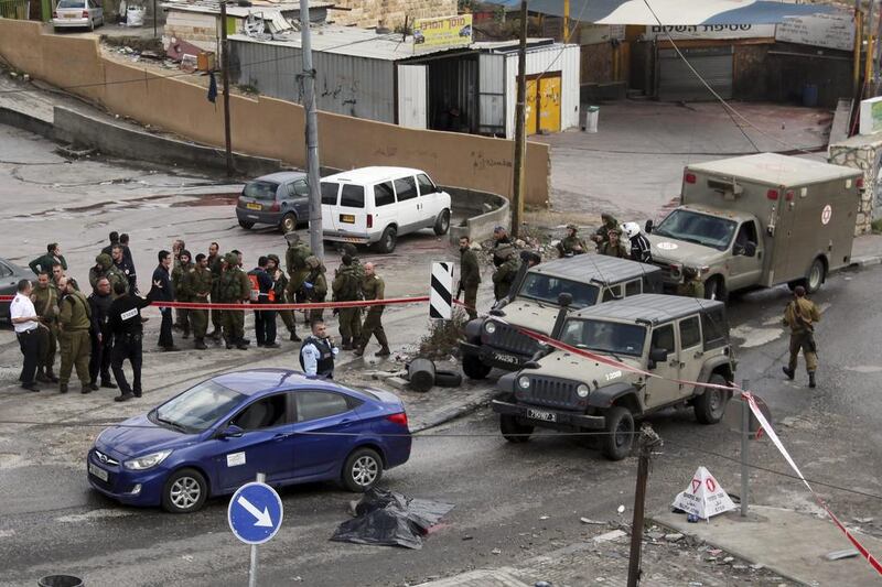 The body of a Palestinian identified as Mazin Hasan Ureiba lies covered with a plastic sheath near the West Bank village of Hizmeh on December 3, 2015. Mahmoud Illean/AP Photo