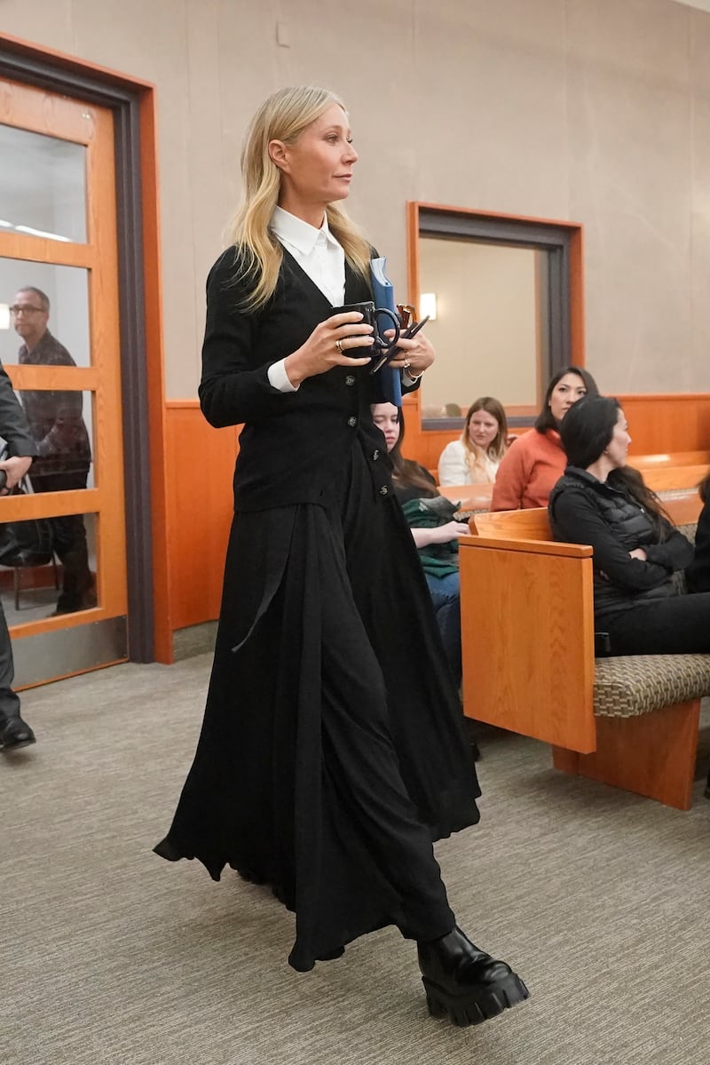 To begin a new week in court on March 27, Paltrow wore a black G.Label by Goop cardigan over a white shirt with a full-length skirt. AP Photo