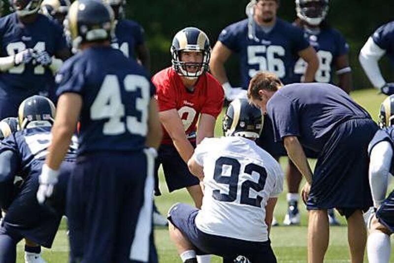 Sam Bradford, in red, calls the play during practice at a team minicamp.
