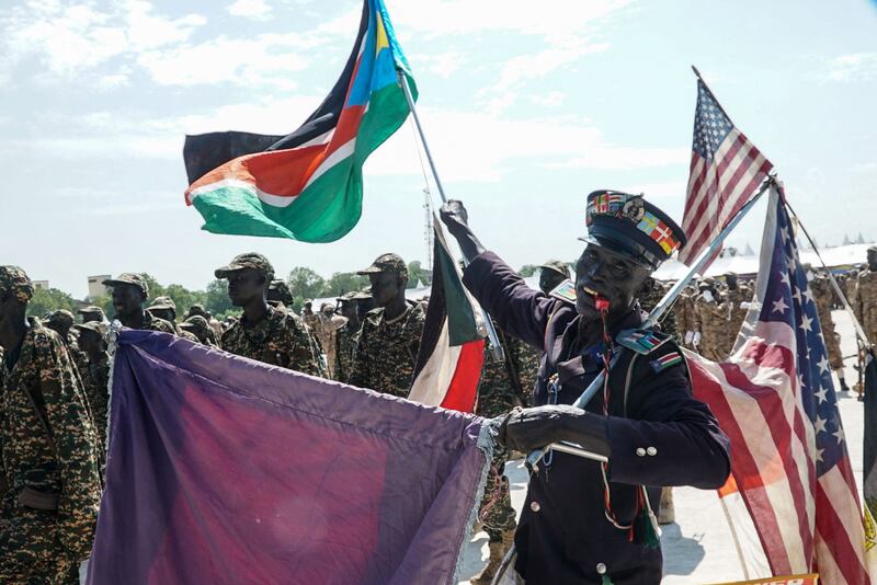 A supporter with US and South Sudan flags during the graduation ceremony for new members of the unified forces at Dr John Garang Mausoleum in Juba on August 30, 2022.  AFP