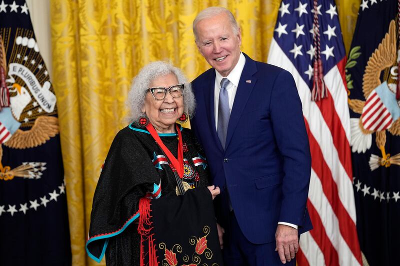 Mr Biden presents the 2021 National Humanities Medal to Native American activist Henrietta Mann. AP