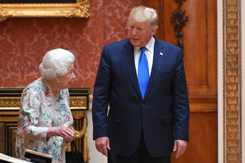 Britain's Queen Elizabeth II (L) views a display of US items of the Royal collection with US President Donald Trump at Buckingham palace at Buckingham Palace in central London. AFP