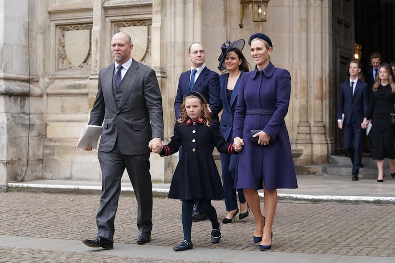 Mike and Zara Tindall, wearing a purple coat, leaving the service of Thanksgiving for the life of the Duke of Edinburgh at Westminster Abbey, London, with daughter Mia, on March 29, 2022. PA Wire 