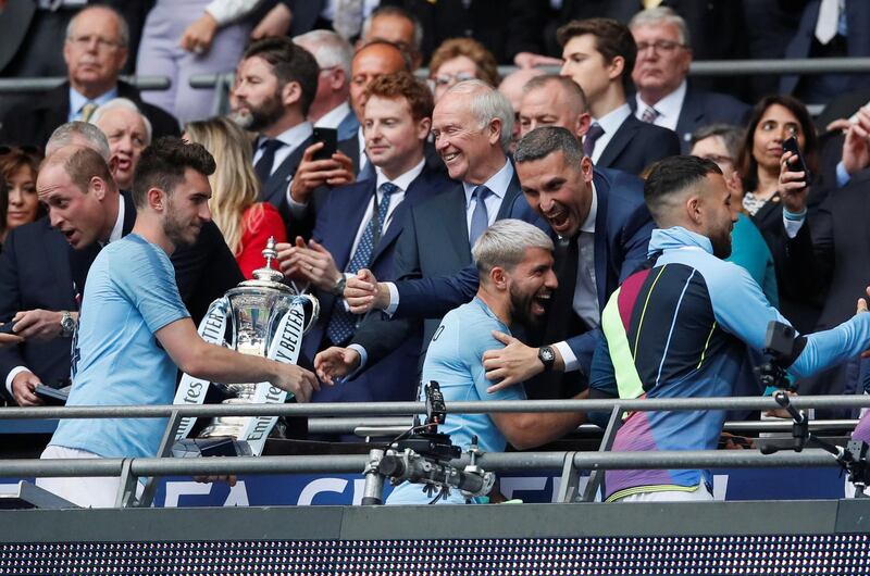 Manchester City's Sergio Aguero, Aymeric Laporte and Manchester City Chairman Khaldoon Al Mubarak celebrate winning the FA Cup. Reuters