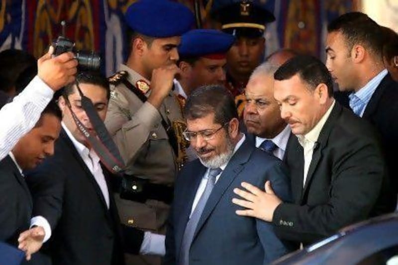Egypt's president-elect Mohamed Morsi, centre, leaves after performing Friday noon prayers at Al Azhar mosque, in Cairo this morning. EPA