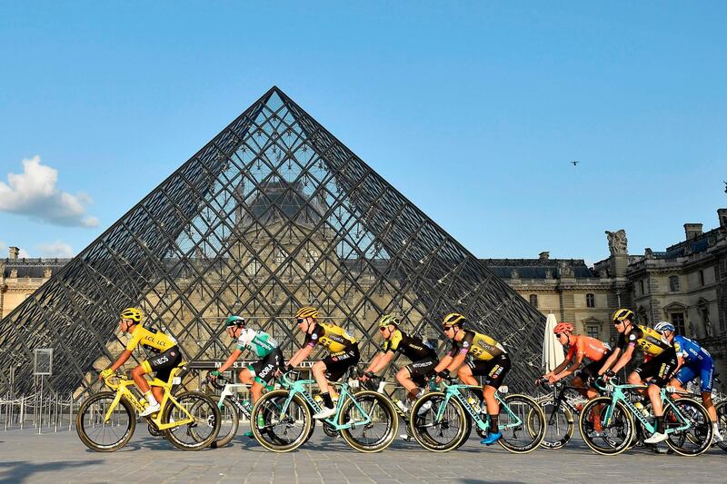 Colombia's Egan Bernal, left, of Team Ineos passes by the Louvre in Paris during the final stage on July 28, 2019. AFP